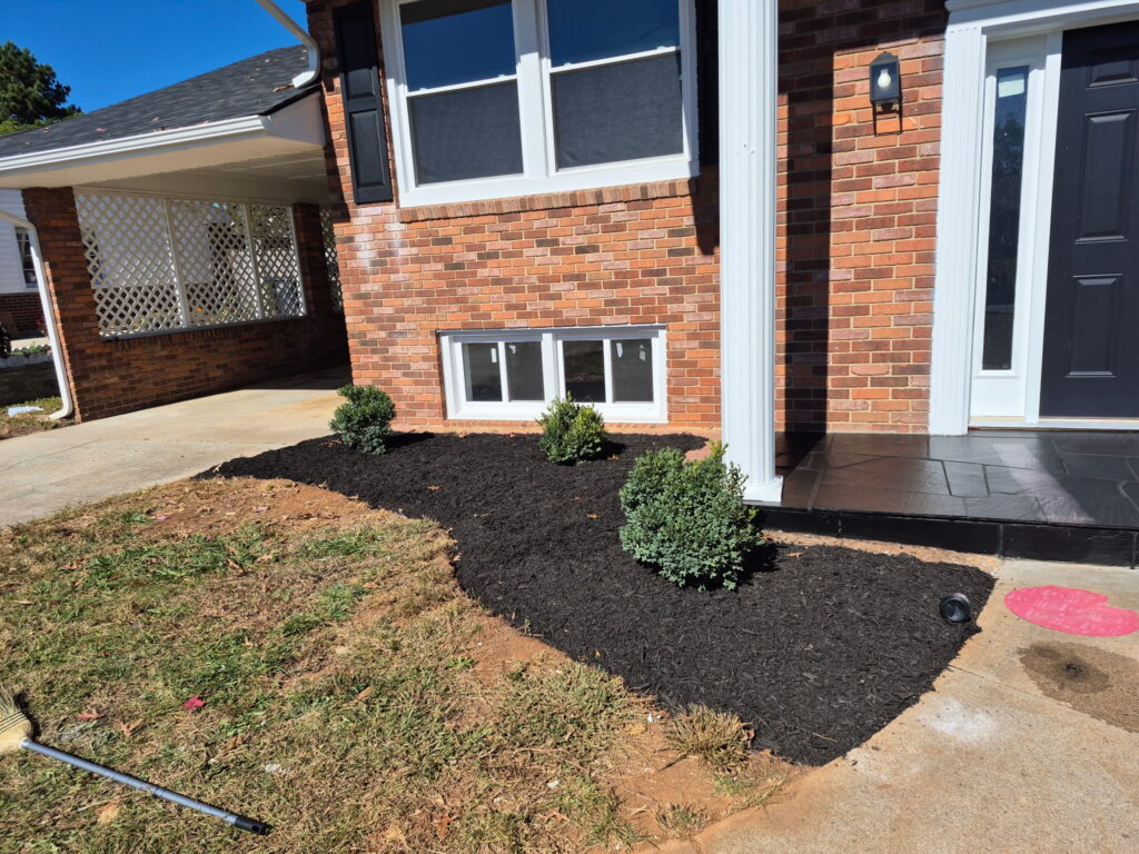 Mulch: Fresh dark mulch installation and garden bed maintenance.