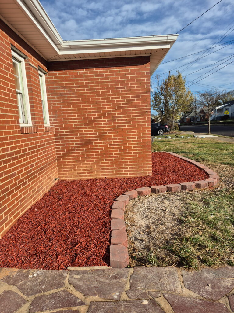 Fresh dark mulch installation and garden bed maintenance.
