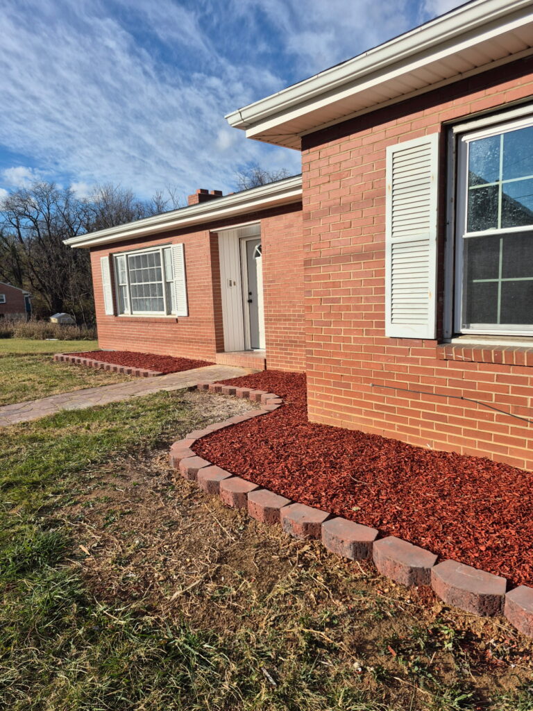 Fresh dark mulch installation and garden bed maintenance.